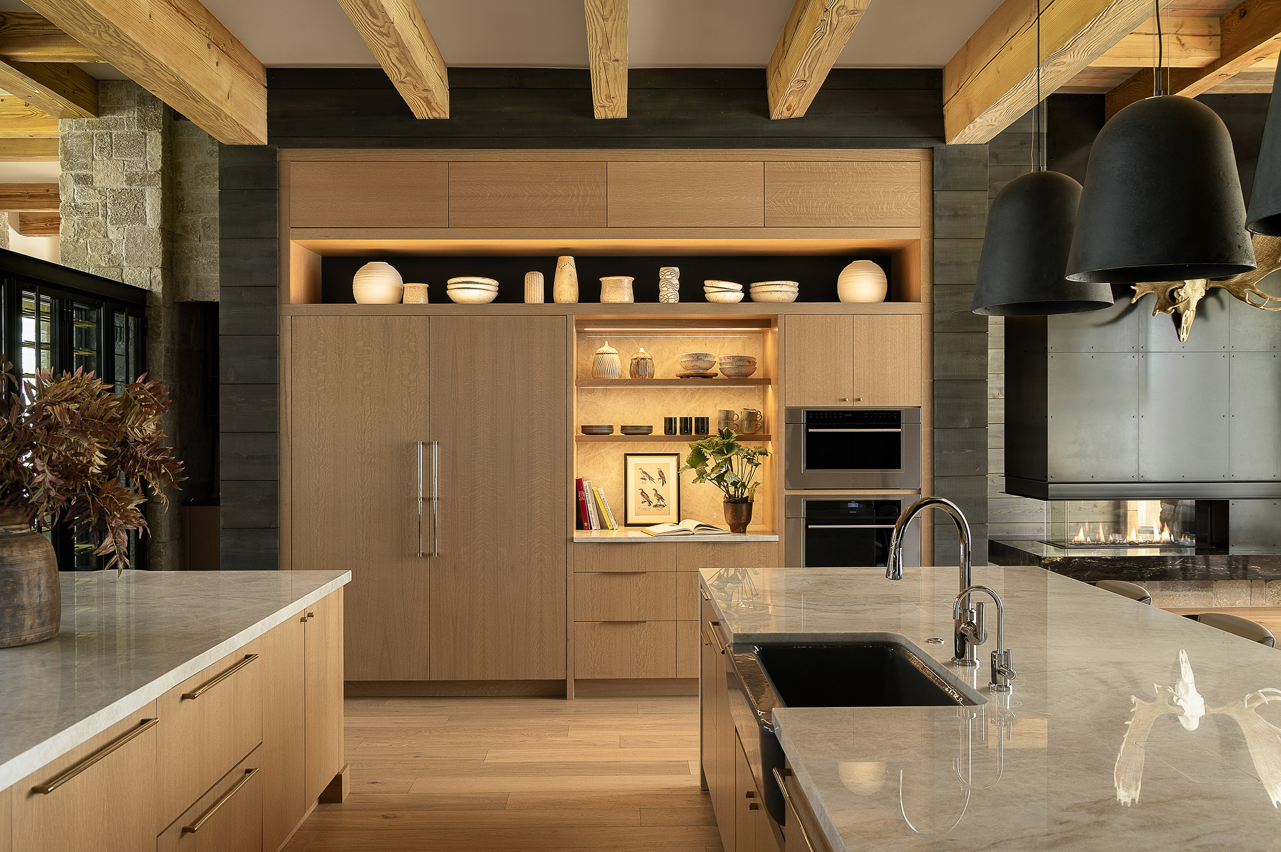 Beautifully remodeled kitchen with a large island featuring a sleek stove with maple blend cabinets in the Laramie door style, painted in the neutral shade of Prairie Dove.