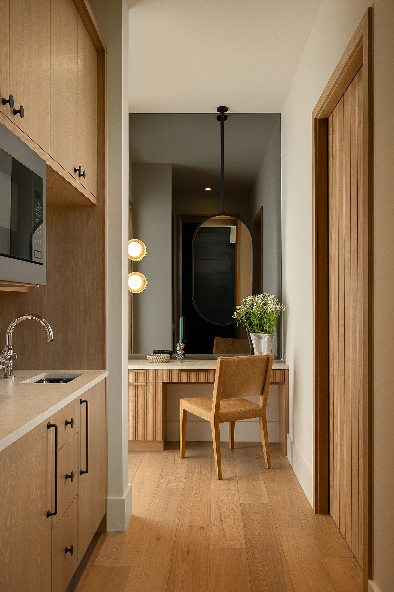 Beautifully remodeled kitchen with a large island featuring a sleek stove with maple blend cabinets in the Laramie door style, painted in the neutral shade of Prairie Dove.