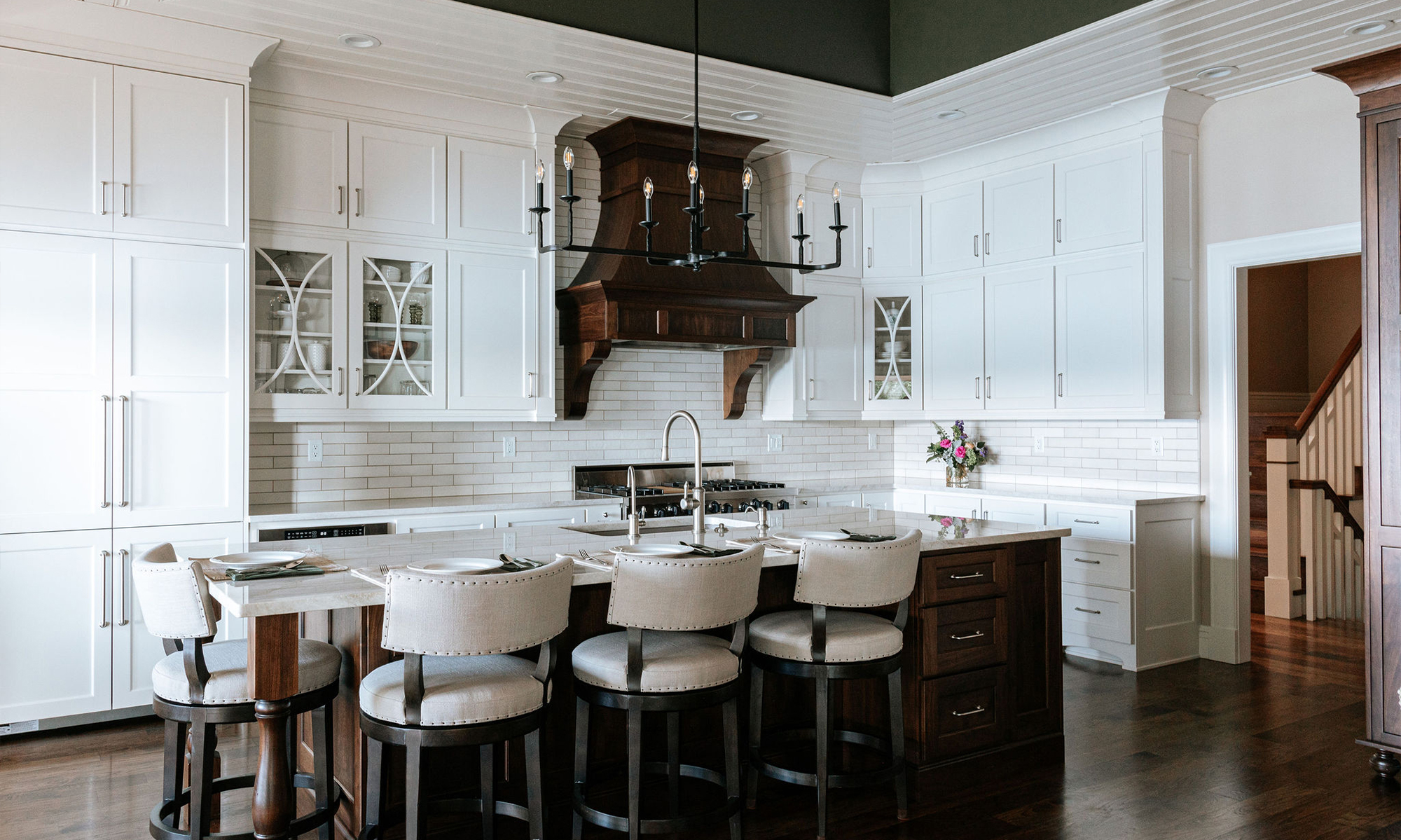 Beautifully remodeled kitchen with a large island featuring a sleek stove with maple blend cabinets in the Laramie door style, painted in the neutral shade of Prairie Dove.