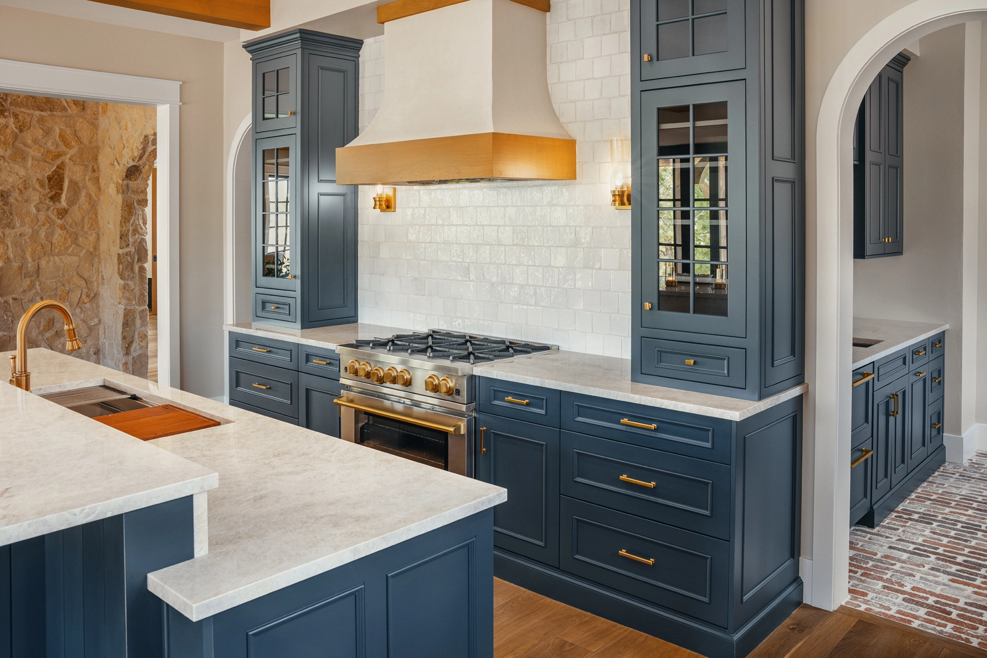 Beautifully remodeled kitchen with a large island featuring a sleek stove with maple blend cabinets in the Laramie door style, painted in the neutral shade of Prairie Dove.