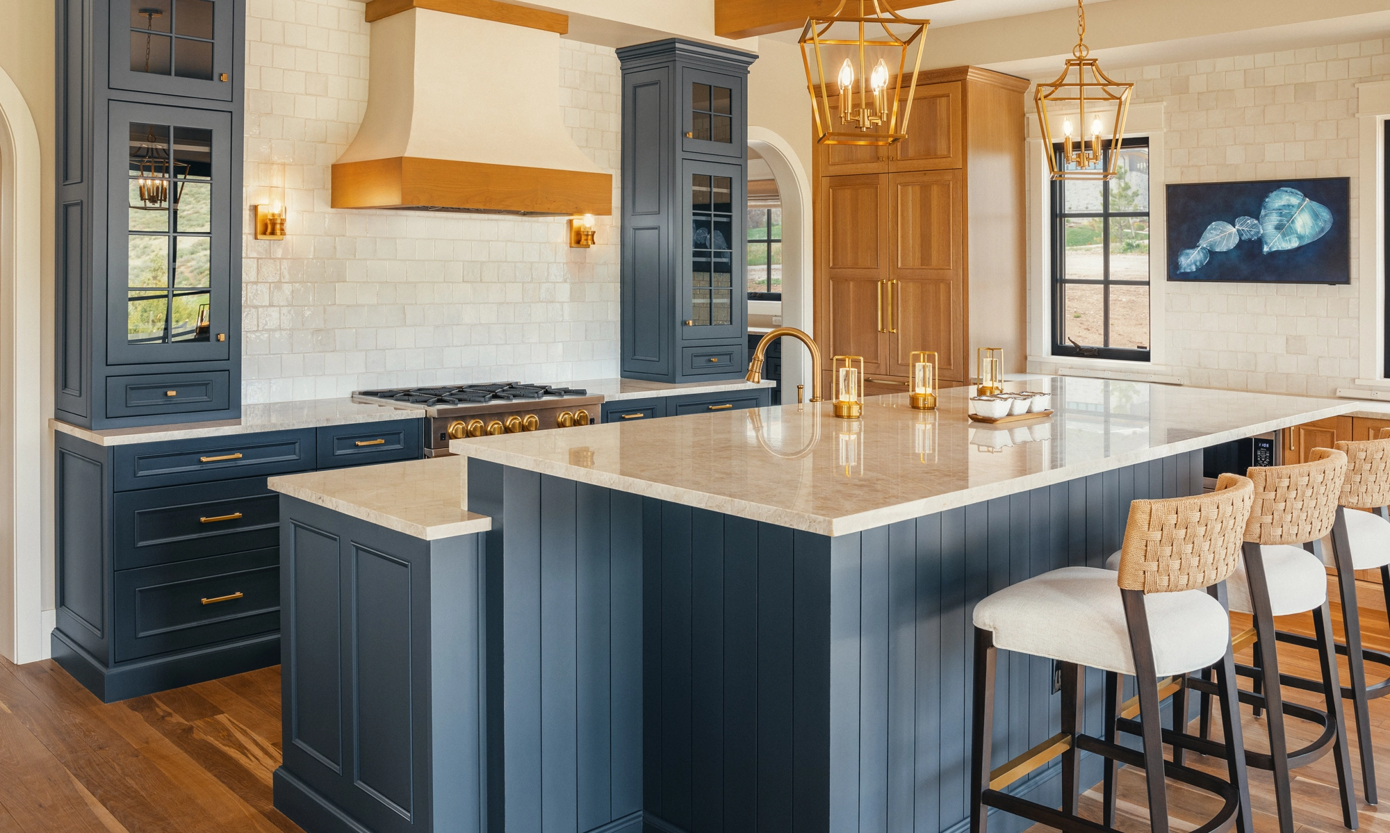 A beautifully remodeled kitchen featuring a sleek stove and maple blend cabinets in the Laramie door style, painted in the neutral shade of Prairie Dove.