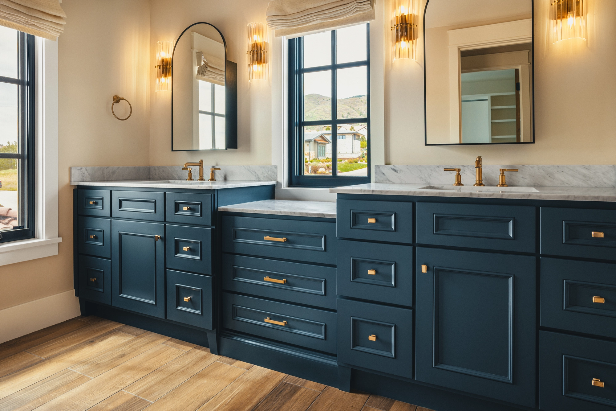 Beautifully remodeled kitchen with a large island featuring a sleek stove with maple blend cabinets in the Laramie door style, painted in the neutral shade of Prairie Dove.